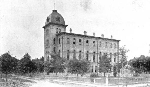 Chapel Hall, a historic multi-story building featuring a tall tower topped with a dome and spire.